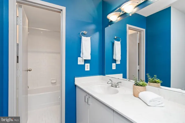 a en suite bathroom with a sink and a mirror