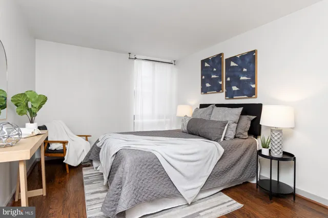 a bedroom with a bed window and a table