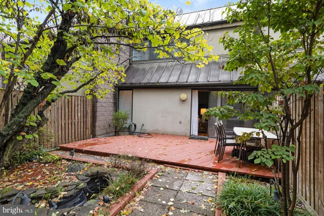 a backyard of a house with table and chairs