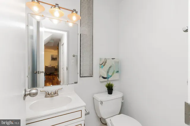 a bathroom with a toilet sink and mirror
