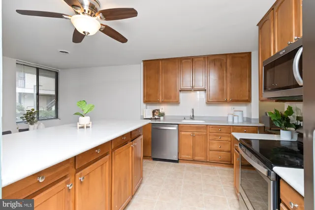 a kitchen with stainless steel appliances granite countertop a sink and stove