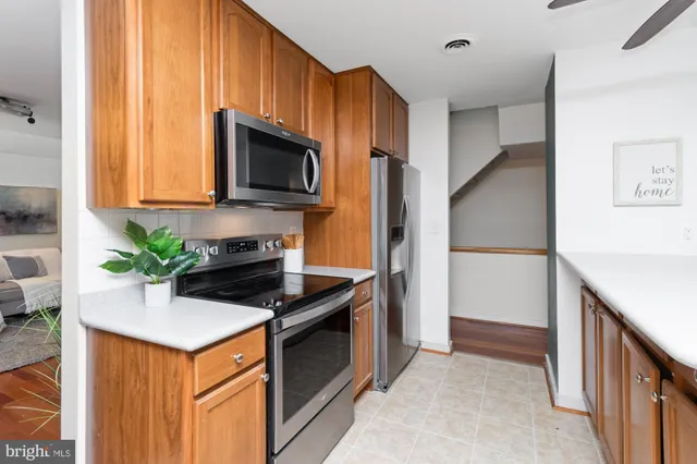 a kitchen with stainless steel appliances a stove a microwave and a sink