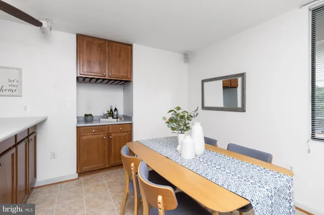 a room with painting on the wall and a dresser