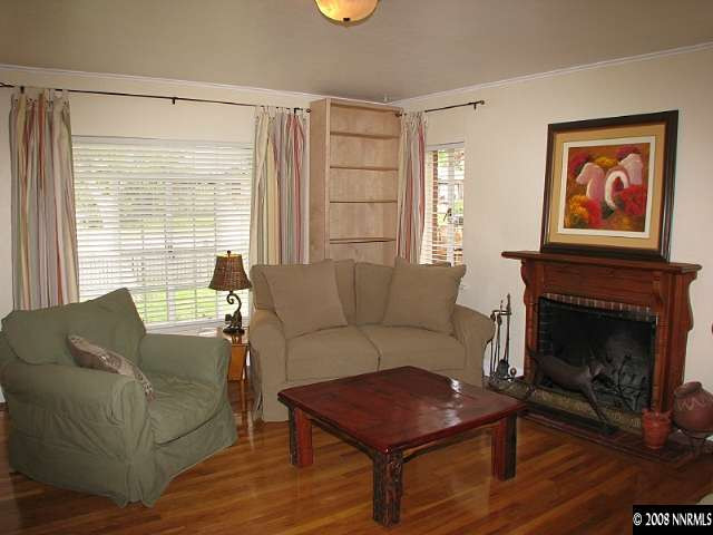 1374 Lander Street Reno, NV 89509 - Photo 2 of 9 a living room with furniture a flat screen tv and a fireplace