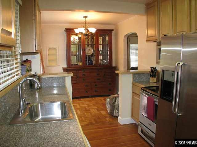 1374 Lander Street Reno, NV 89509 - Photo 3 of 9 a kitchen with a sink stove and refrigerator