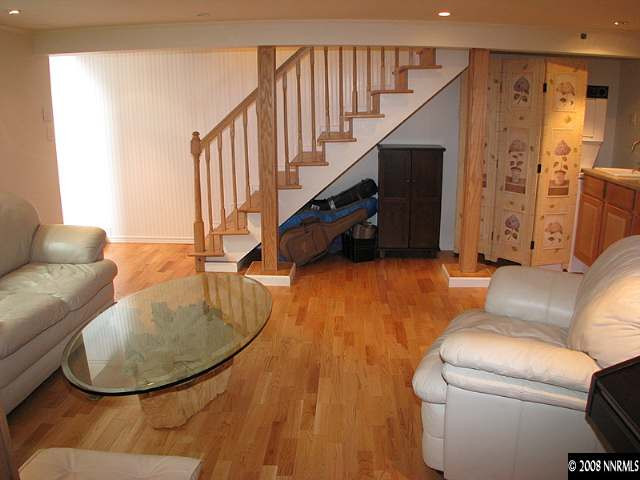 1374 Lander Street Reno, NV 89509 - Photo 7 of 9 a living room with furniture and a chandelier