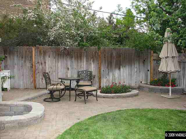 1374 Lander Street Reno, NV 89509 - Photo 8 of 9 a backyard of a house with table and chairs