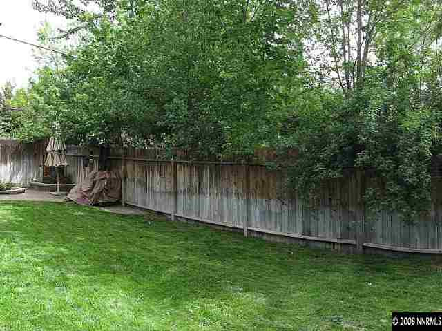 1374 Lander Street Reno, NV 89509 - Photo 9 of 9 a view of a backyard with potted plants and large trees