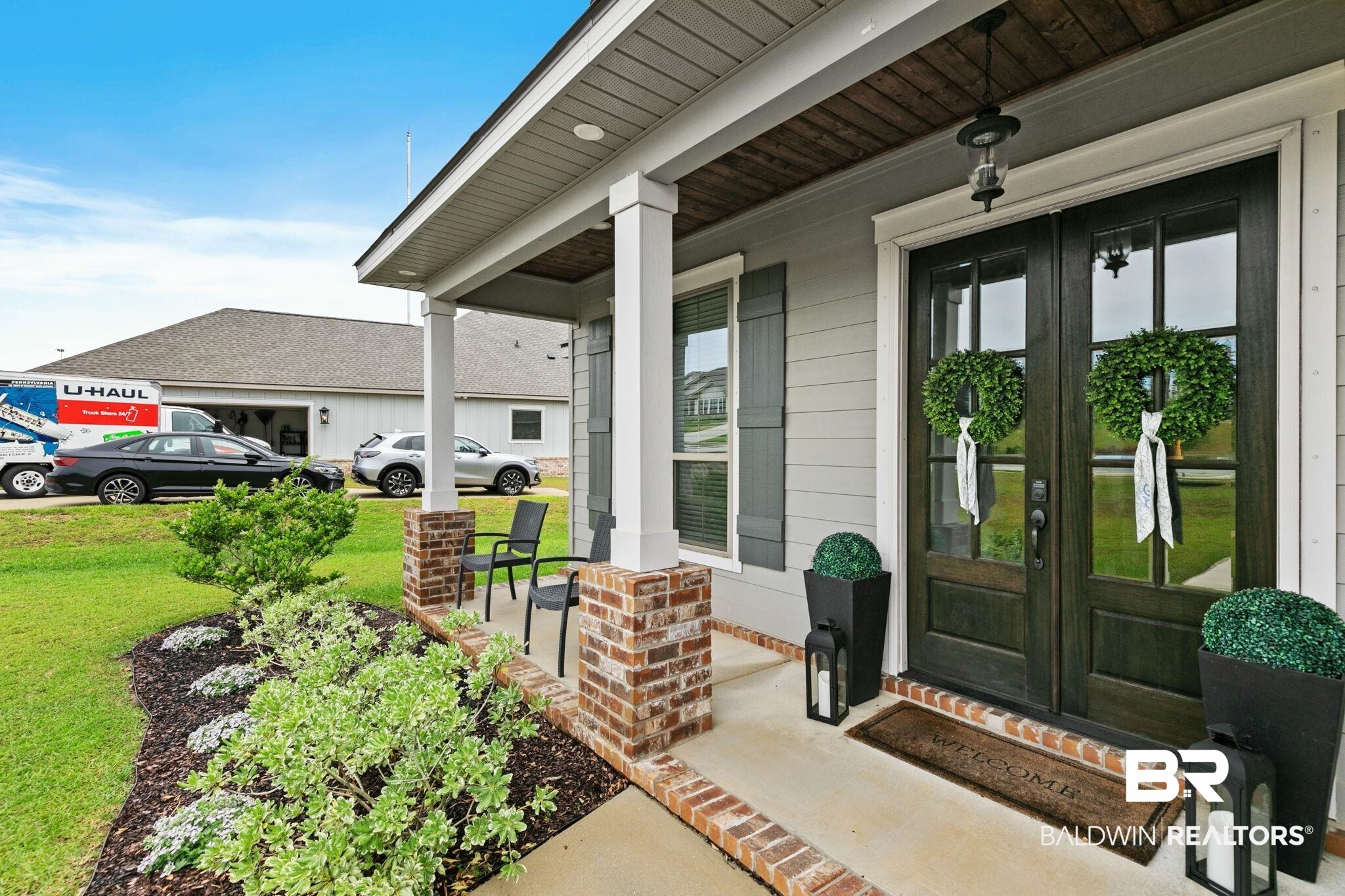 13233 Ibis Boulevard Daphne, AL 36527 - Photo 4 of 100 Covered front porch featuring brick-wrapped columns and a wood-finish ceiling