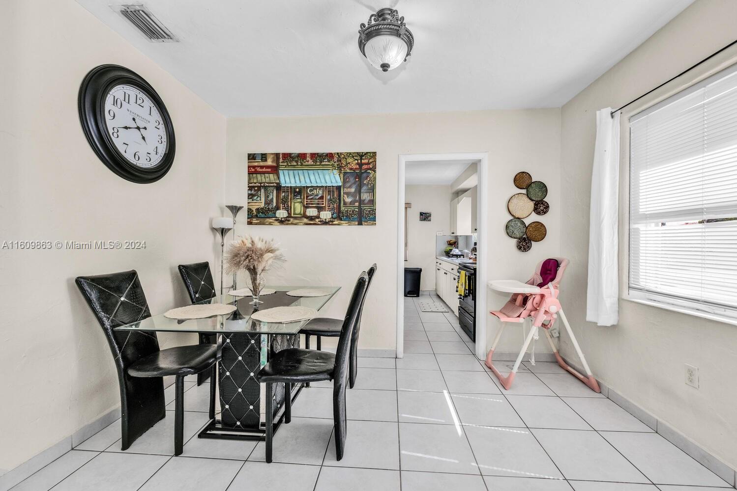 3430 Southwest 11th Street Miami, FL 33135 - Photo 13 of 21 a view of a dining area with furniture and a large window