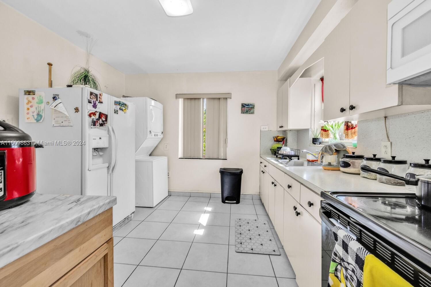 3430 Southwest 11th Street Miami, FL 33135 - Photo 15 of 21 a kitchen with stainless steel appliances a stove a sink and a refrigerator