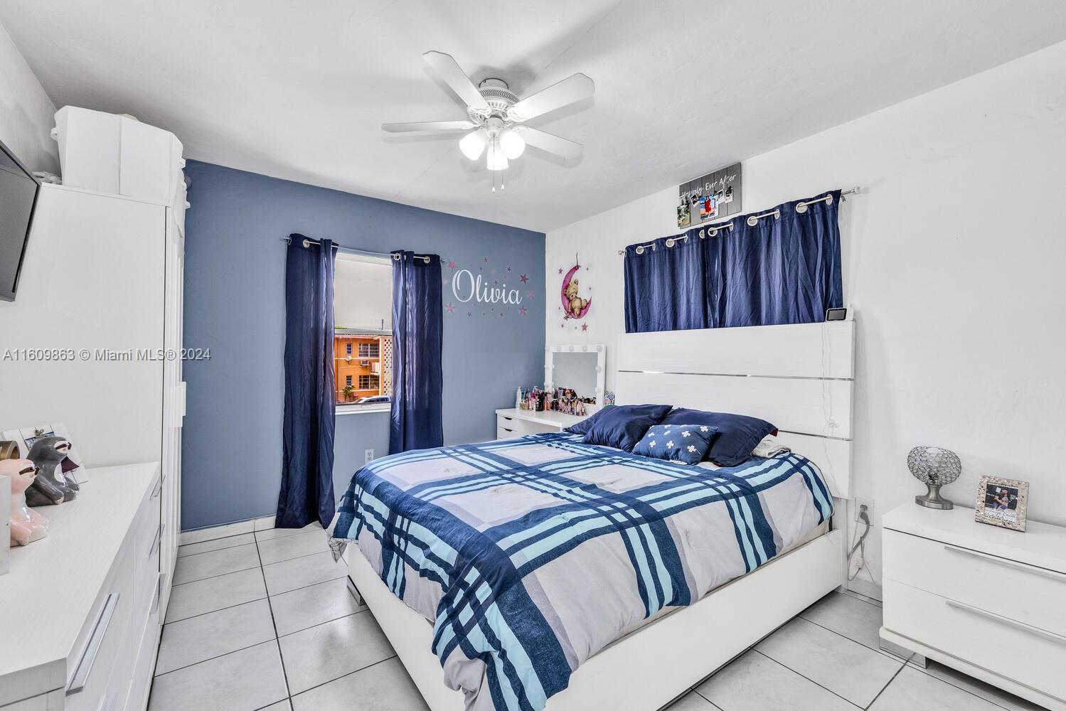 3430 Southwest 11th Street Miami, FL 33135 - Photo 17 of 21 a bedroom with a bed and a chandelier