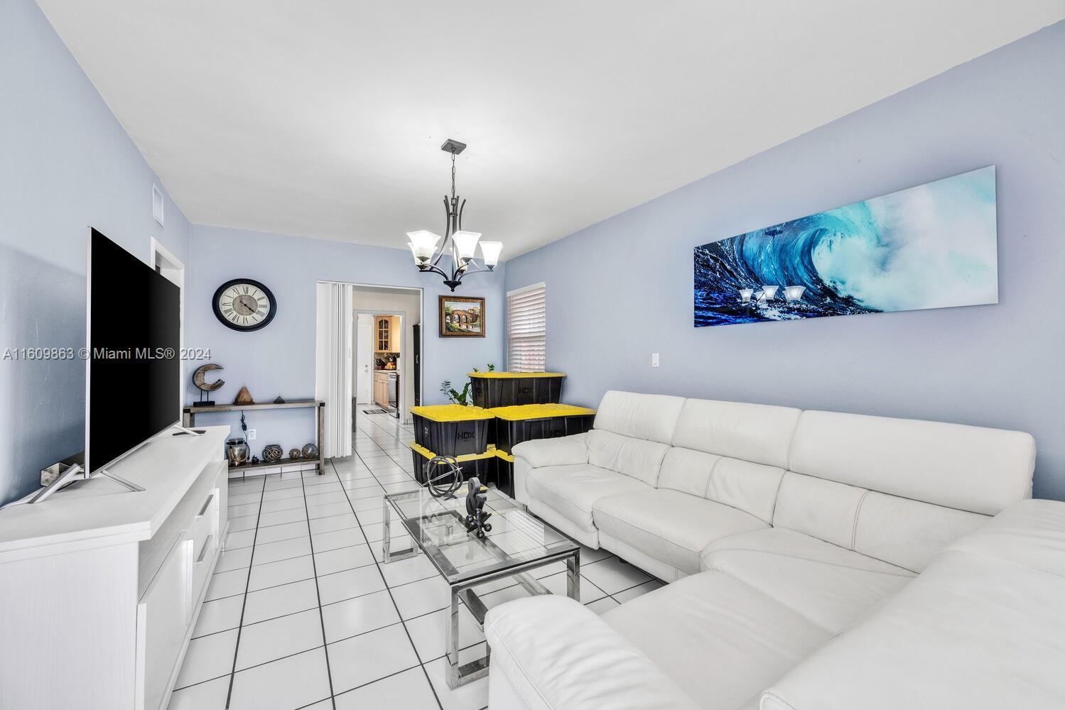 3430 Southwest 11th Street Miami, FL 33135 - Photo 3 of 21 a living room with furniture a rug and a chandelier