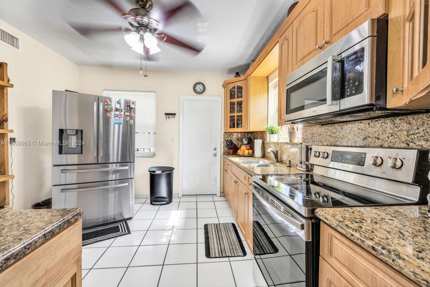 3430 Southwest 11th Street Miami, FL 33135 - Photo 5 of 21 a kitchen with stainless steel appliances granite countertop a refrigerator and a stove
