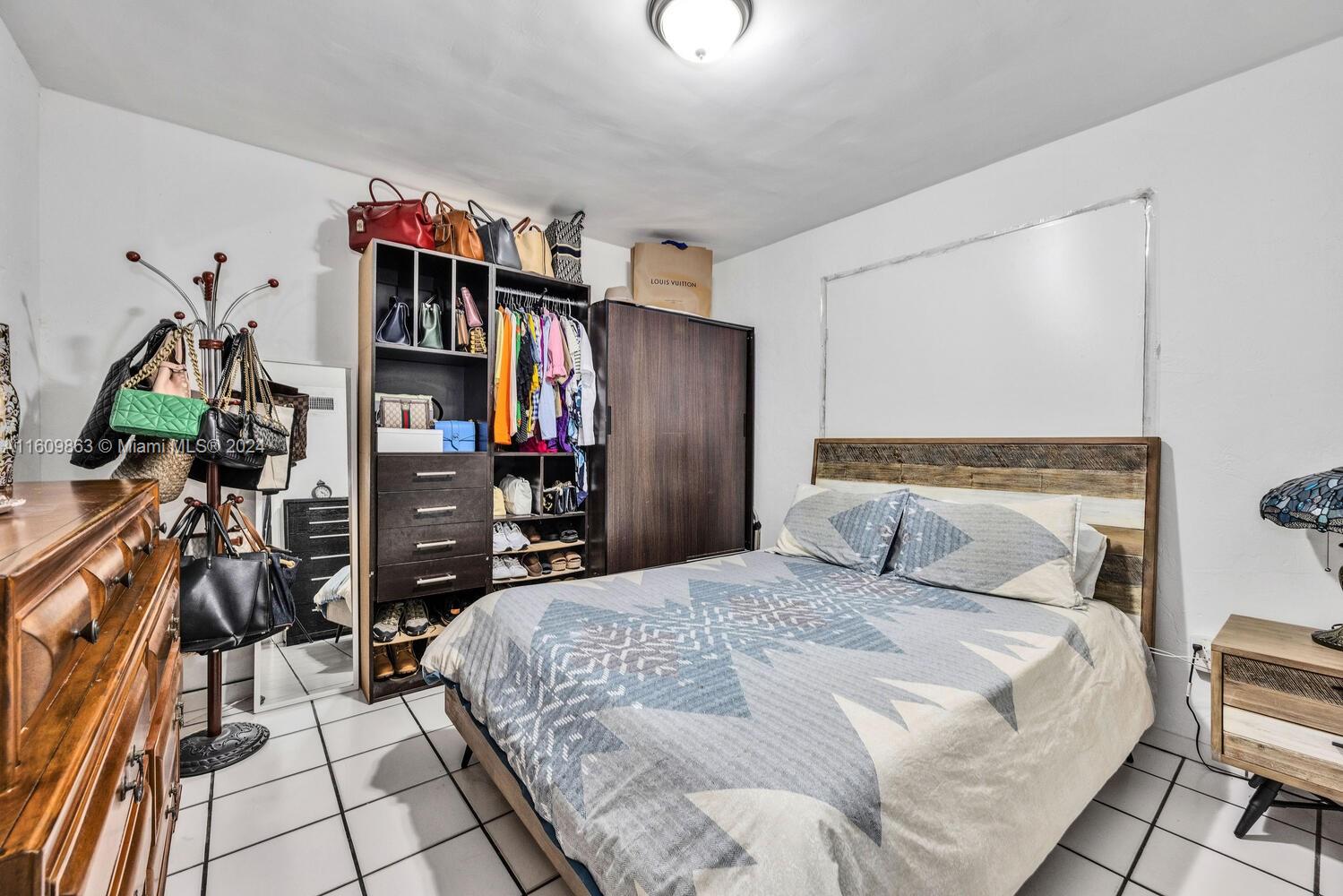 3430 Southwest 11th Street Miami, FL 33135 - Photo 7 of 21 a bedroom with a bed and a walk in closet