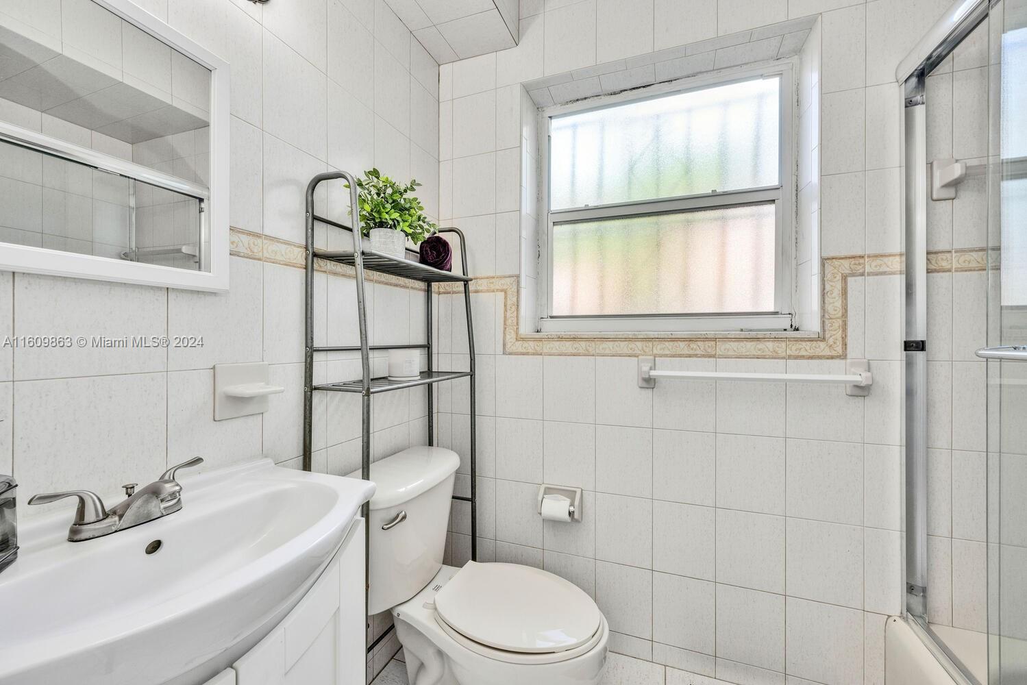 3430 Southwest 11th Street Miami, FL 33135 - Photo 9 of 21 a bathroom with a sink a toilet and shower