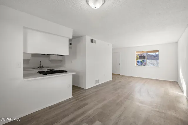 a kitchen with stainless steel appliances a stove a refrigerator and a more cabinets