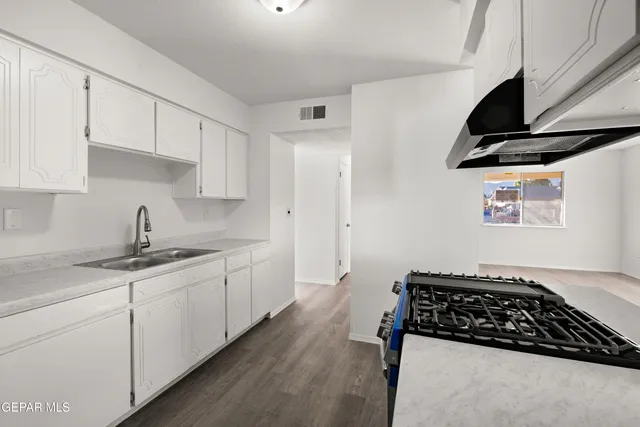 an empty room with a window and a ceiling fan