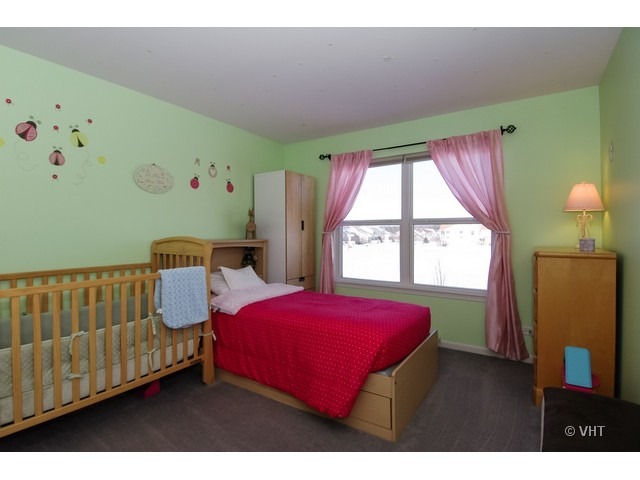 914 Oak Ridge Boulevard Elgin, IL 60120 - Photo 12 of 15 a bedroom with a bed and a window