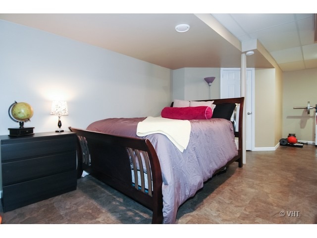 914 Oak Ridge Boulevard Elgin, IL 60120 - Photo 13 of 15 a bedroom with a bed and a lamp