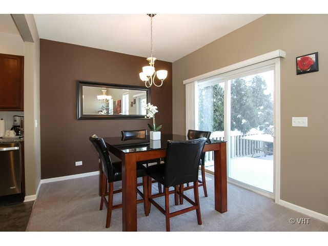 914 Oak Ridge Boulevard Elgin, IL 60120 - Photo 7 of 15 a dining room with furniture a large window and a chandelier