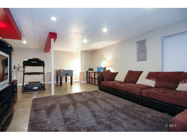 914 Oak Ridge Boulevard Elgin, IL 60120 - Photo 8 of 15 a living room with furniture and a flat screen tv