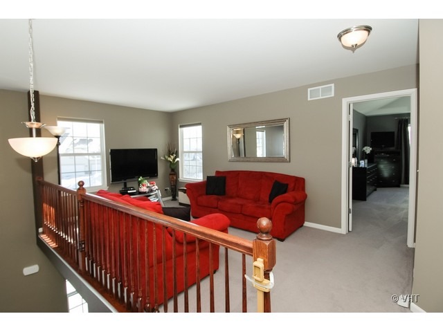 914 Oak Ridge Boulevard Elgin, IL 60120 - Photo 9 of 15 a living room with furniture and a flat screen tv