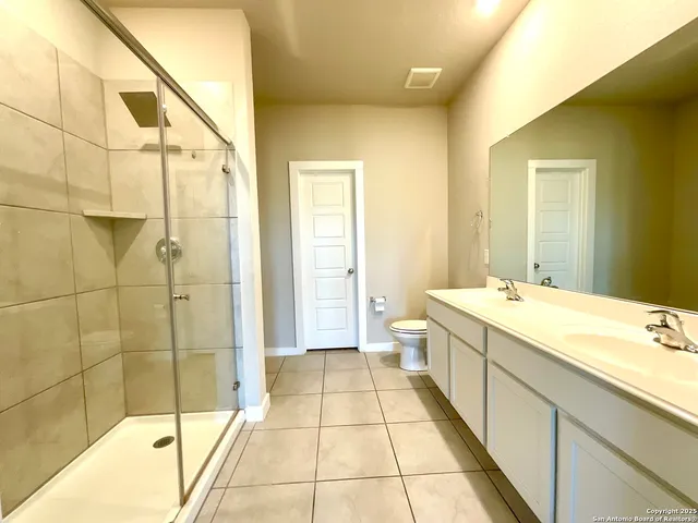 a spacious bathroom with a tub and shower