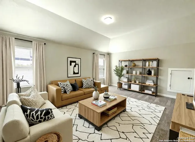 a living room with furniture and a table