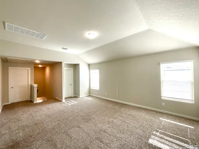 an empty room with windows and closet