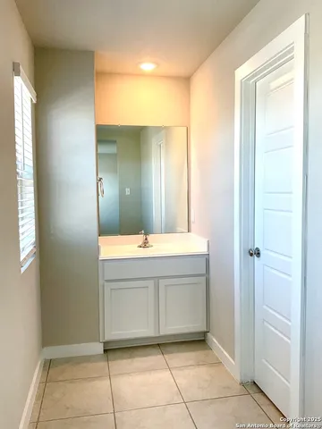 a bathroom with a sink a mirror and a bathtub