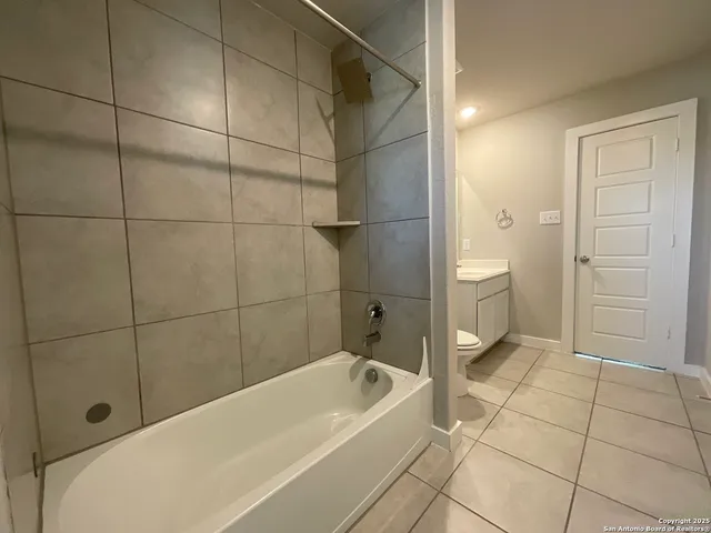 a bathroom with a bathtub and shower
