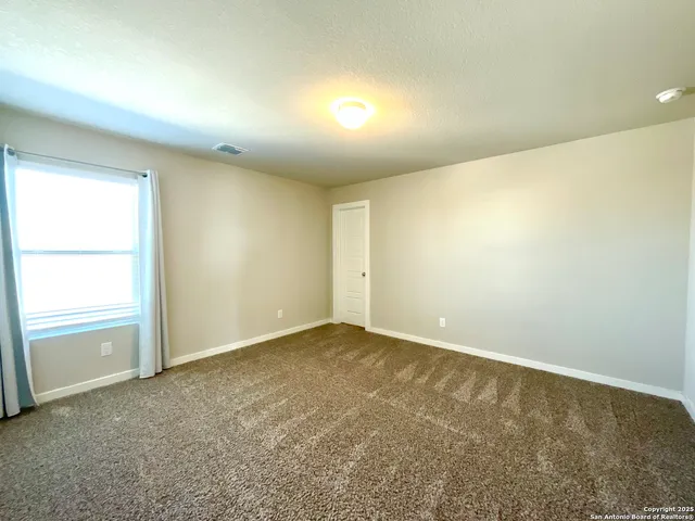 an empty room with a empty space and a window