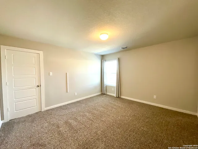 an empty room with closet area