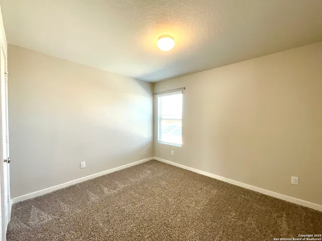 an empty room with a empty space and a window