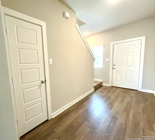 an empty room with wooden floor and closet