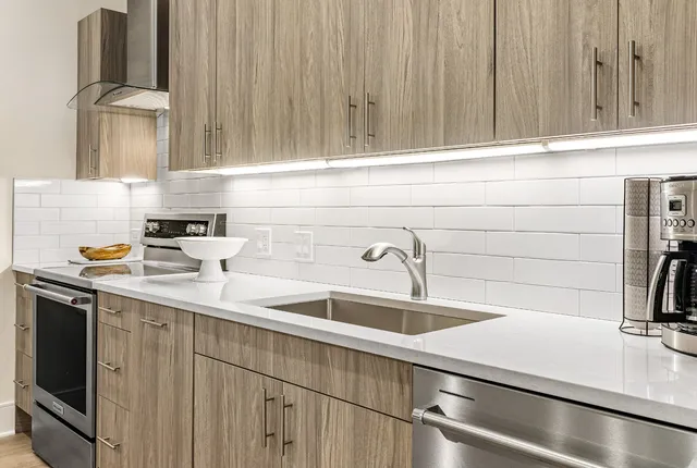 a kitchen with stainless steel appliances a sink and cabinets