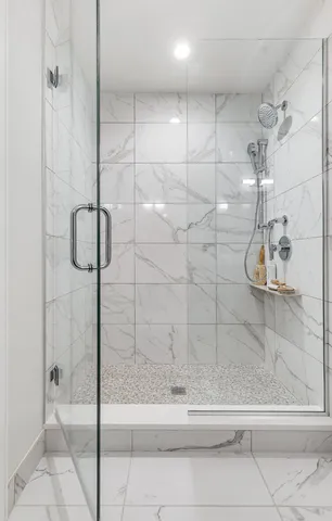 a bathroom with a glass shower door
