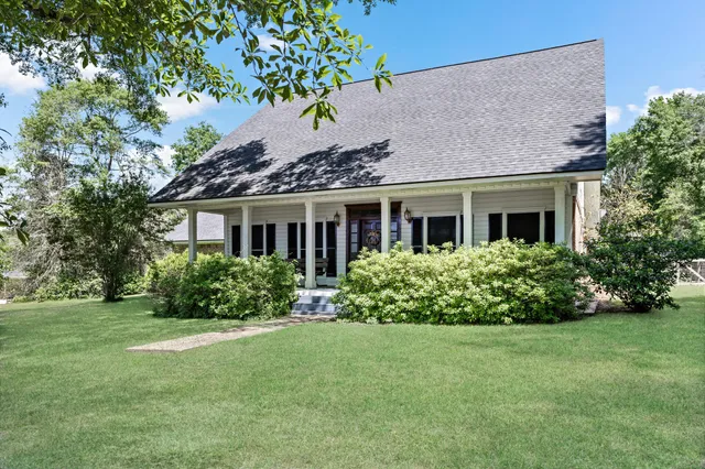 a front view of house with yard and green space
