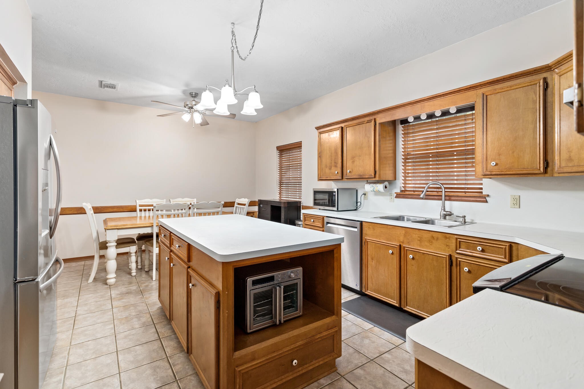 3084 Highway 63 Jasper, TX 75951 - Photo 14 of 44 a open kitchen with stainless steel appliances granite countertop a stove a sink dishwasher and a refrigerator