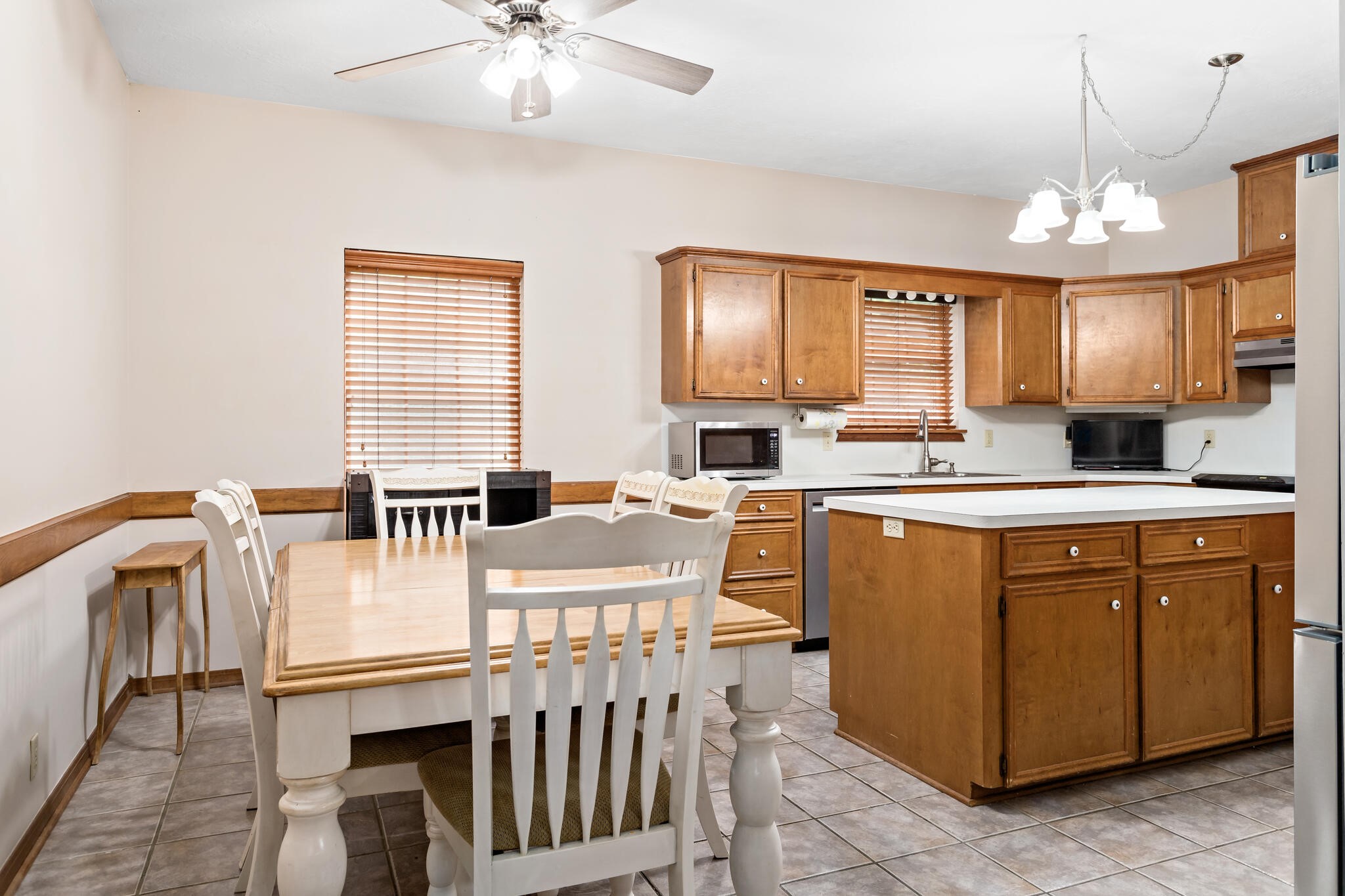 3084 Highway 63 Jasper, TX 75951 - Photo 17 of 44 a kitchen with stainless steel appliances granite countertop a stove a sink a microwave a dining table and chairs with wooden floor