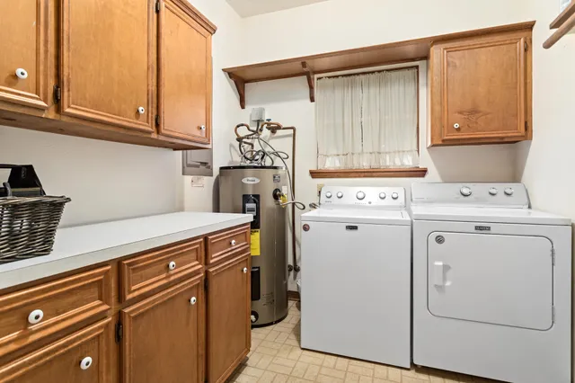 a view of a storage and utility room with washer and dryer