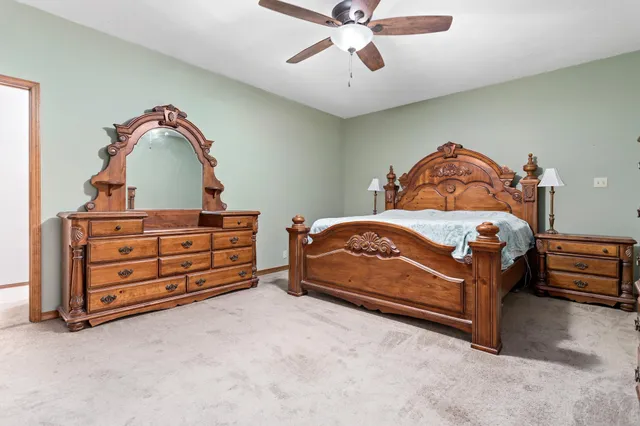 a bedroom with a bed and a dresser