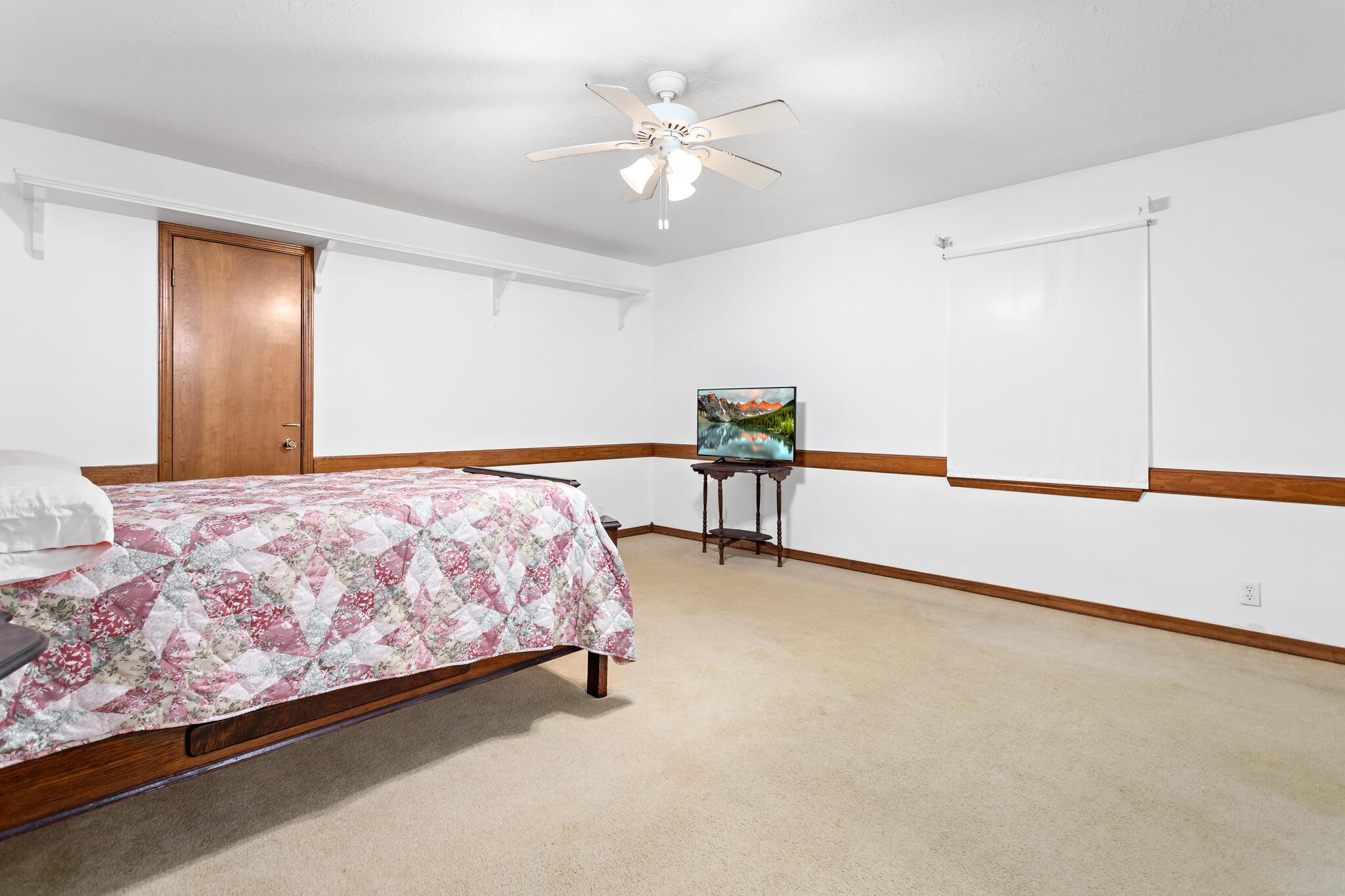 3084 Highway 63 Jasper, TX 75951 - Photo 26 of 44 a bedroom with a bed and a chandelier