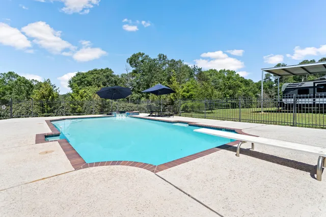 a view of table and chairs under an umbrella