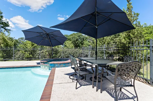 an aerial view of a house with yard and patio