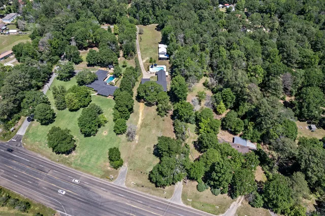 an aerial view of a house with a yard