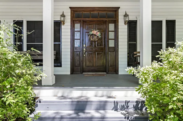 a view of lobby with glass door and potted plants