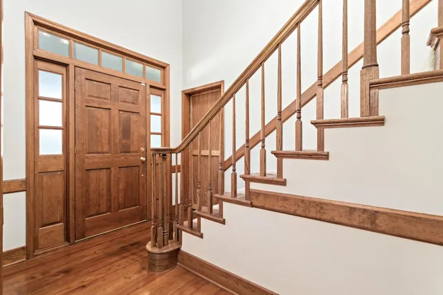 a view of entryway with wooden floor and stairs