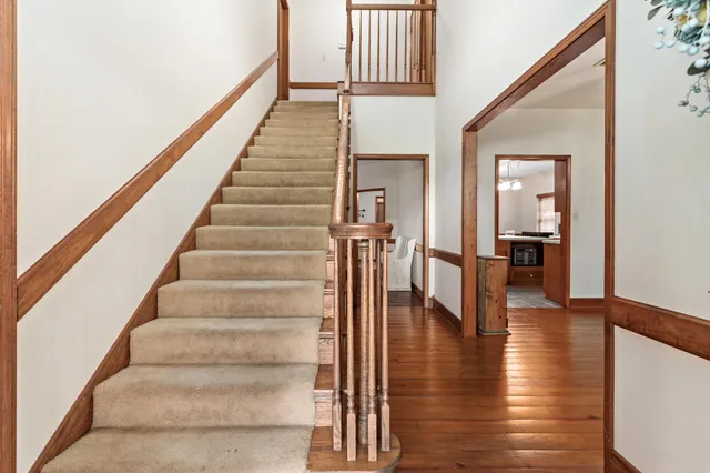 a view of an entryway with wooden floor and a floor to ceiling window